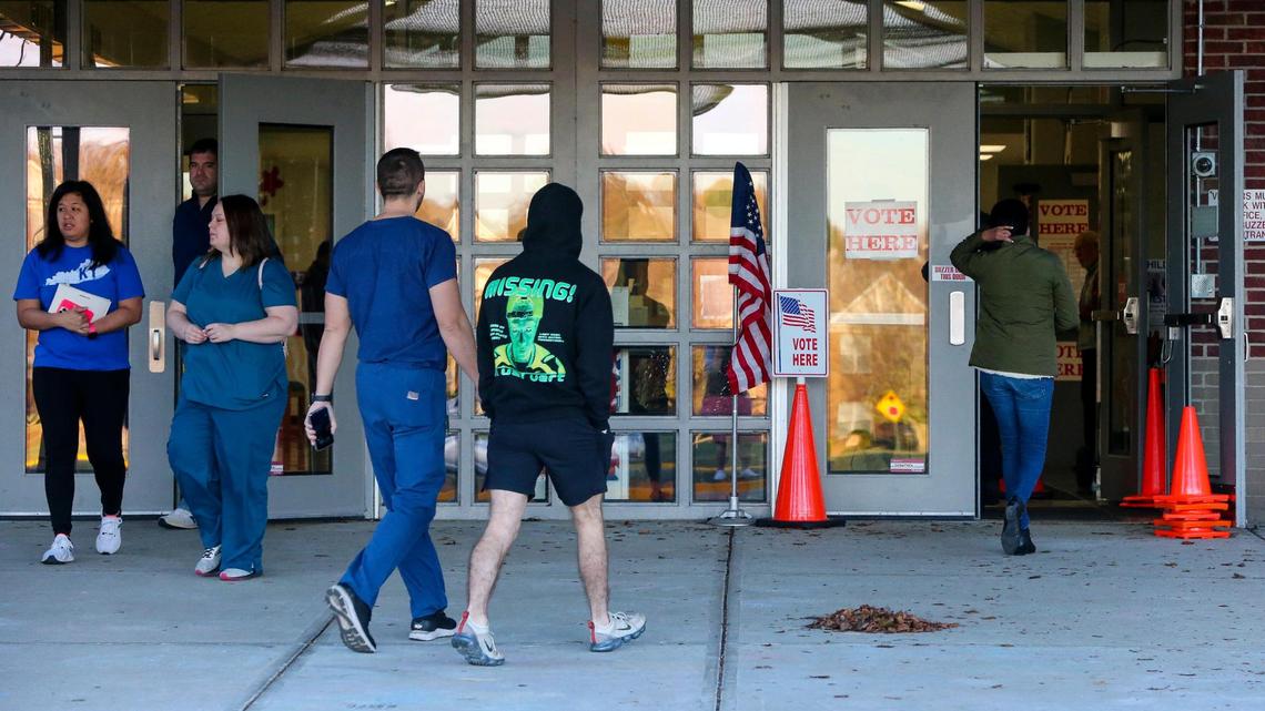 Voters enter and leave Veterans Park Elementary School to cast ballots on election day, Tuesday, Nov. 8, 2022 in Lexington, Ky.