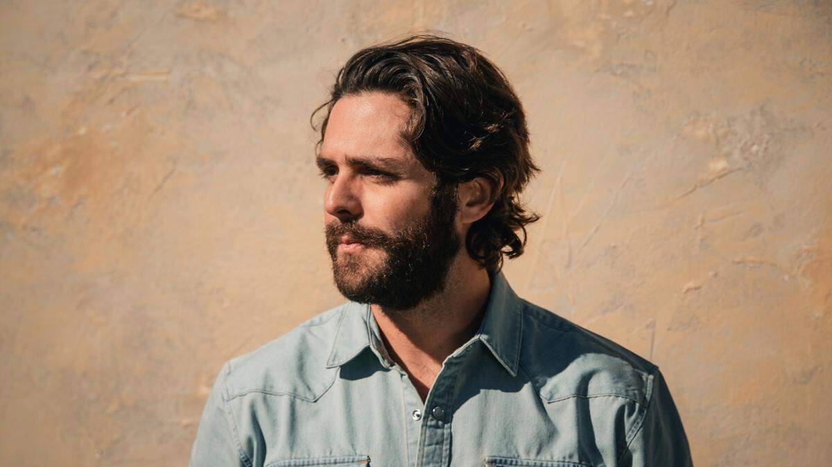 Prolific songwriter Thomas Rhett jokes that he’s “trying to keep up with Taylor Swift” by releasing three albums in three years with more on the way.