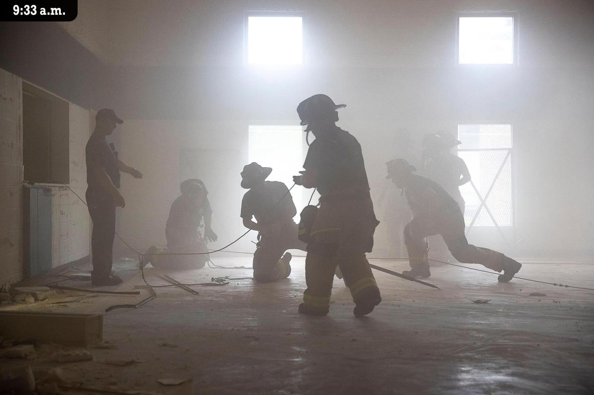 Members of the Lexington Fire Department participate in a training exercise with simulated smoke Friday, July 9 at a structure on Armstrong Mill Road. The firefighters were practicing rope-assisted large-area search techniques. In another training scenario in the basement of the structure, teams practiced rescuing an injured firefighter by first finding them in total darkness, and then carrying a 200-pound mannequin up a flight of stairs. Battalion Chief Jordan Saas said training reinforces the concept of continuous improvement and builds muscle memory and confidence for the firefighters. “This allows our crews to operate more efficiently and seamlessly during actual emergencies, when fractions of time really do determine the outcomes of life or death situations,” he explained.