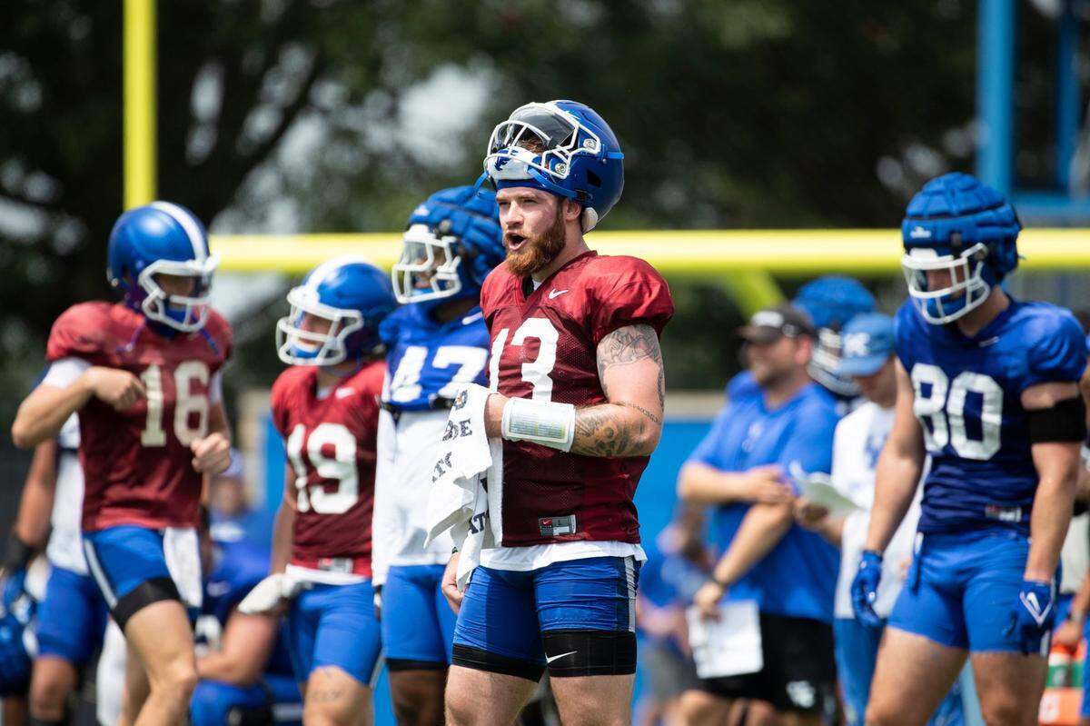 New Kentucky quarterback Devin Leary (13) shouts to his teammates during the Wildcats’ Fan Day open practice in Lexington on Saturday.