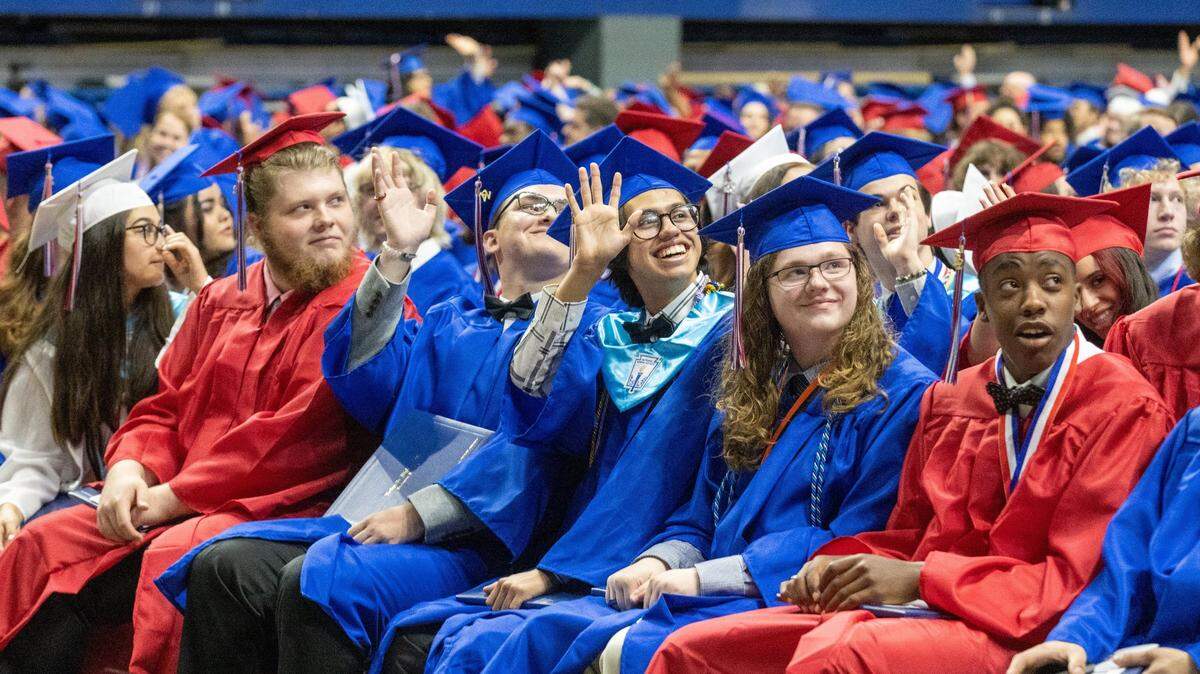 Lafayette High School graduating seniors wave at family and friends in the stands during the commencement ceremony at Rupp Arena, May 27, 2022.