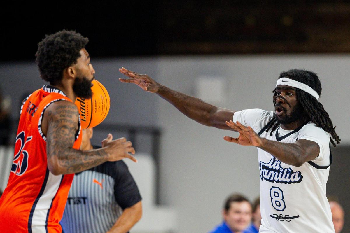 La Familia forward Khalil Whitney guards War Ready forward Laron Smith during Sunday’s TBT game against War Ready at Memorial Coliseum.