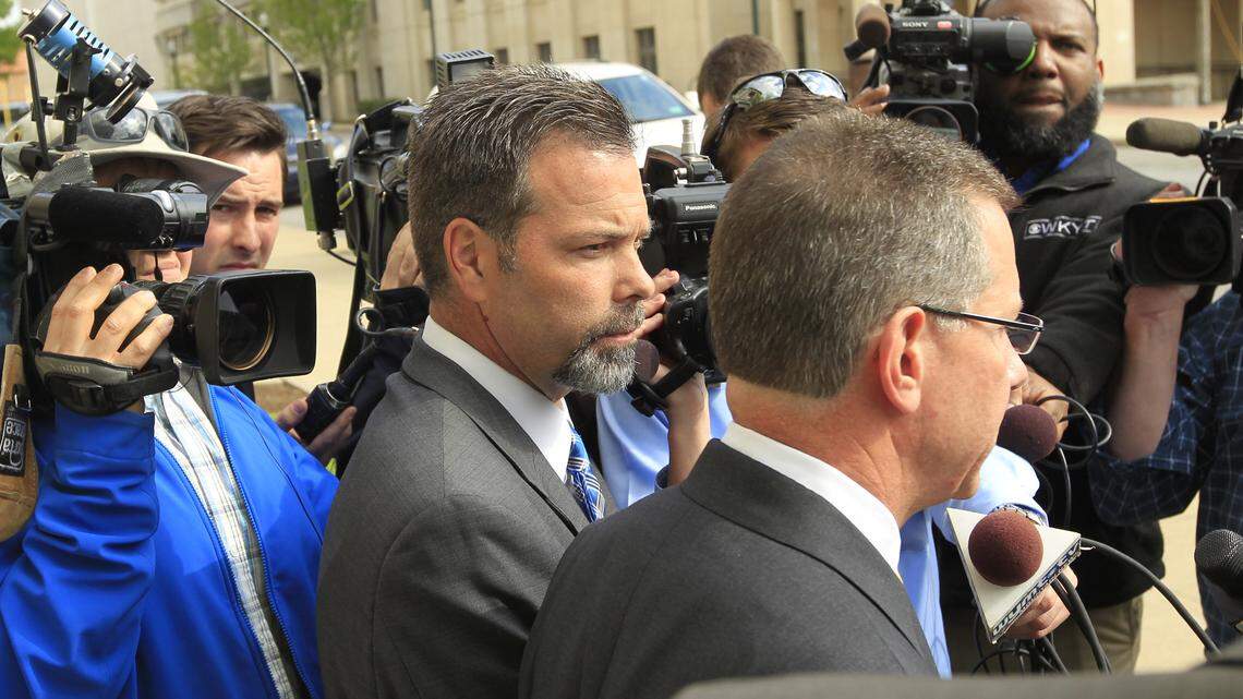 Former Agriculture Commissioner Richie Farmer, left, stood silent as his attorney J. Guthrie True gave a statement Thursday outside the federal courthouse in Lexington. Farmer pleaded not guilty to federal charges that he misused more than $450,000 in state money and property during his eight years as Kentucky's top agriculture official.  Photo by Pablo Alcalá | Staff