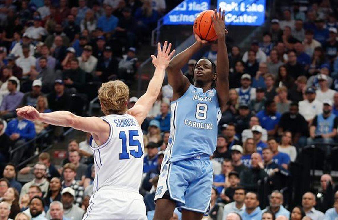 SALT LAKE CITY, UT - OCTOBER 24: Caleb Wilson #8 of the North Carolina Tar Heels shoots a three pointer over Richie Saunders #15 of the Brigham Young Cougars during the second half of their exhibition game at the Delta Center on October 24, 2025 in Salt Lake City, Utah. (Photo by Chris Gardner/Getty Images)