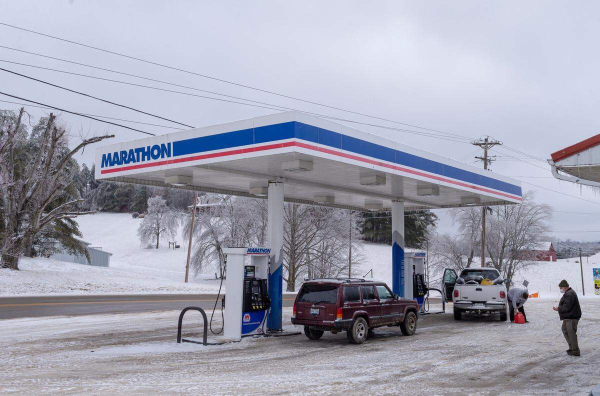 People fill up their cars and gas cans at the Gray Hawk Landing in Jackson County, Ky., Wednesday, February 17, 2020. Jackson County was hit hard by the winter storm that brought snow and ice to the area knocking out power and water for many residents. The National Weather Service has forecasted another winter storm to drop more snow Wednesday night and Thursday.