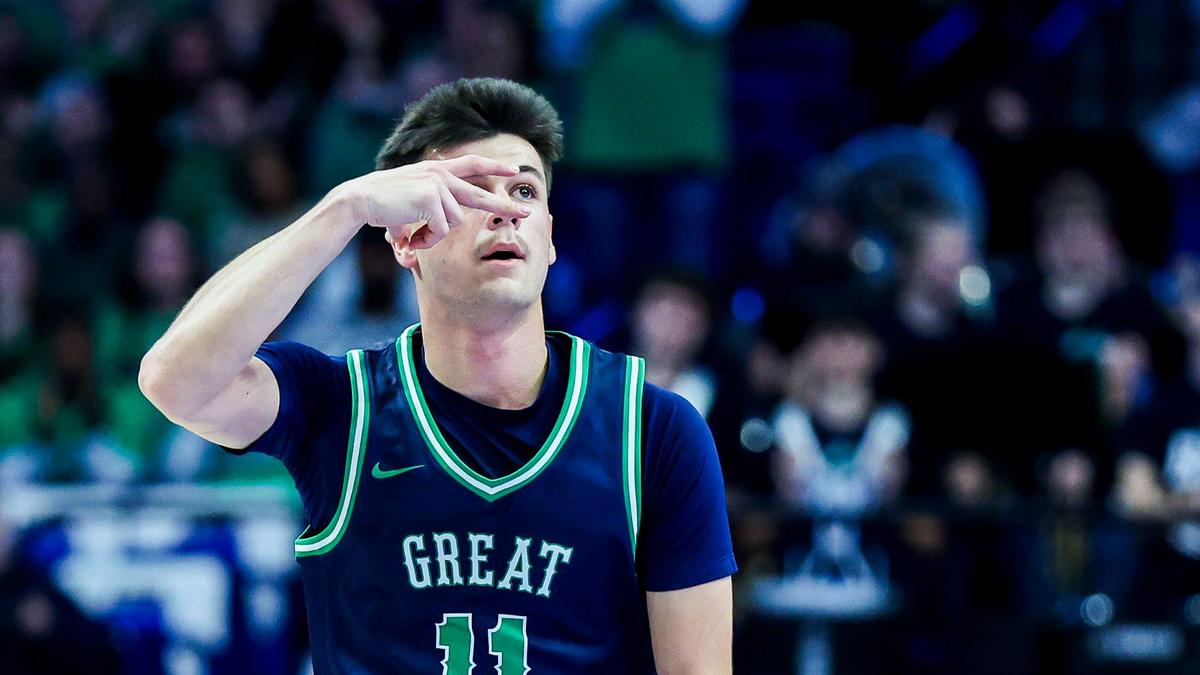 Great Crossing’s Gage Richardson (11) celebrates after making a first-half 3-pointer during the Warhawks’ 69-37 win in Rupp Arena.