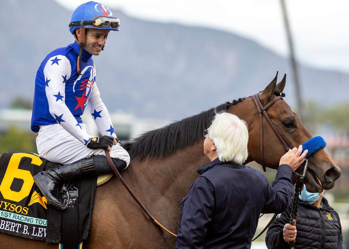 Nysos’ trainer, Bob Baffert, congratulates jockey Flavien Prat after winning the Grade 3, $200,000 Robert B. Lewis Stakes on Saturday at Santa Anita Park in Arcadia, Calif.