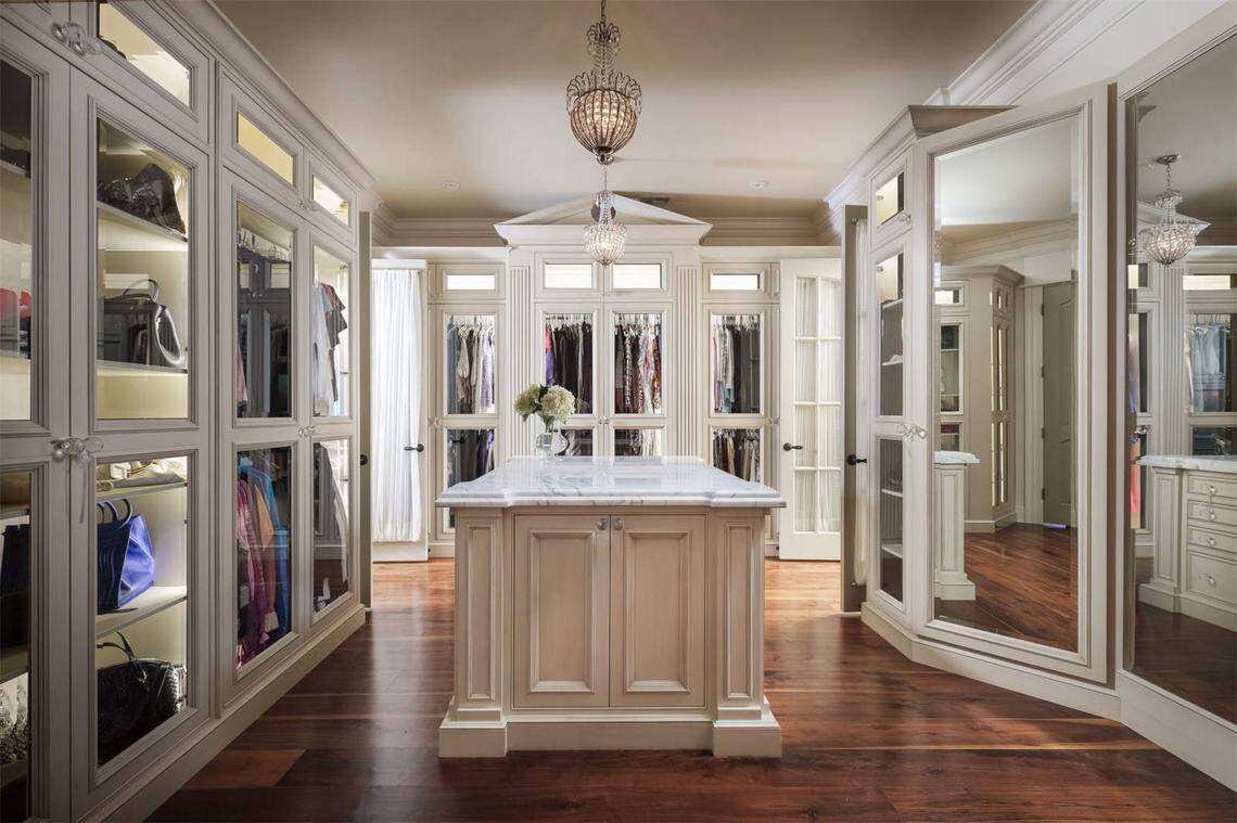 The house is for sale by sealed-bid auction with a minimum bid of $3.7 million. This is part of the closet. Note the lighted handbag closet.