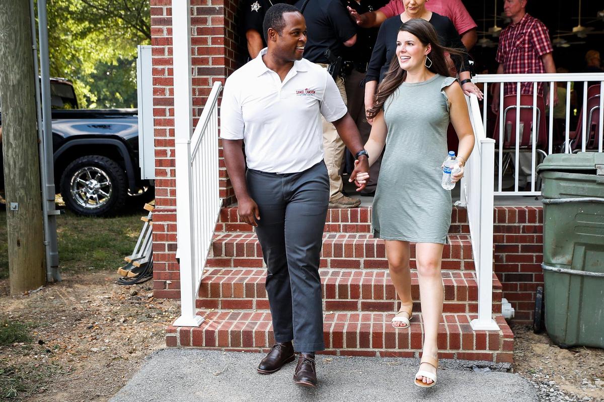 Attorney General Daniel Cameron and his wife Makenze, leave the state after speaking during the 141st Fancy Farm Picnic at St. Jerome Catholic Church in Fancy Farm, Ky., Saturday, Aug. 7, 2021.