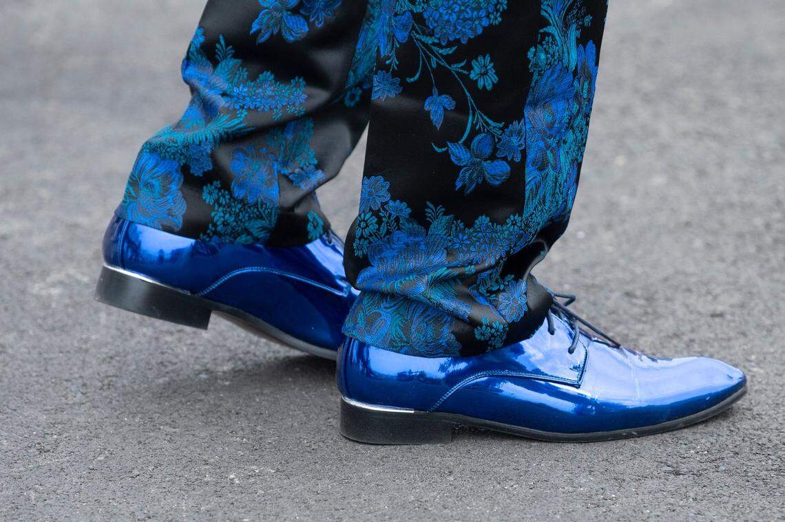 People walk around Churchill Downs ahead of the Kentucky Derby in Louisville, Ky., on Saturday, May 6, 2023.