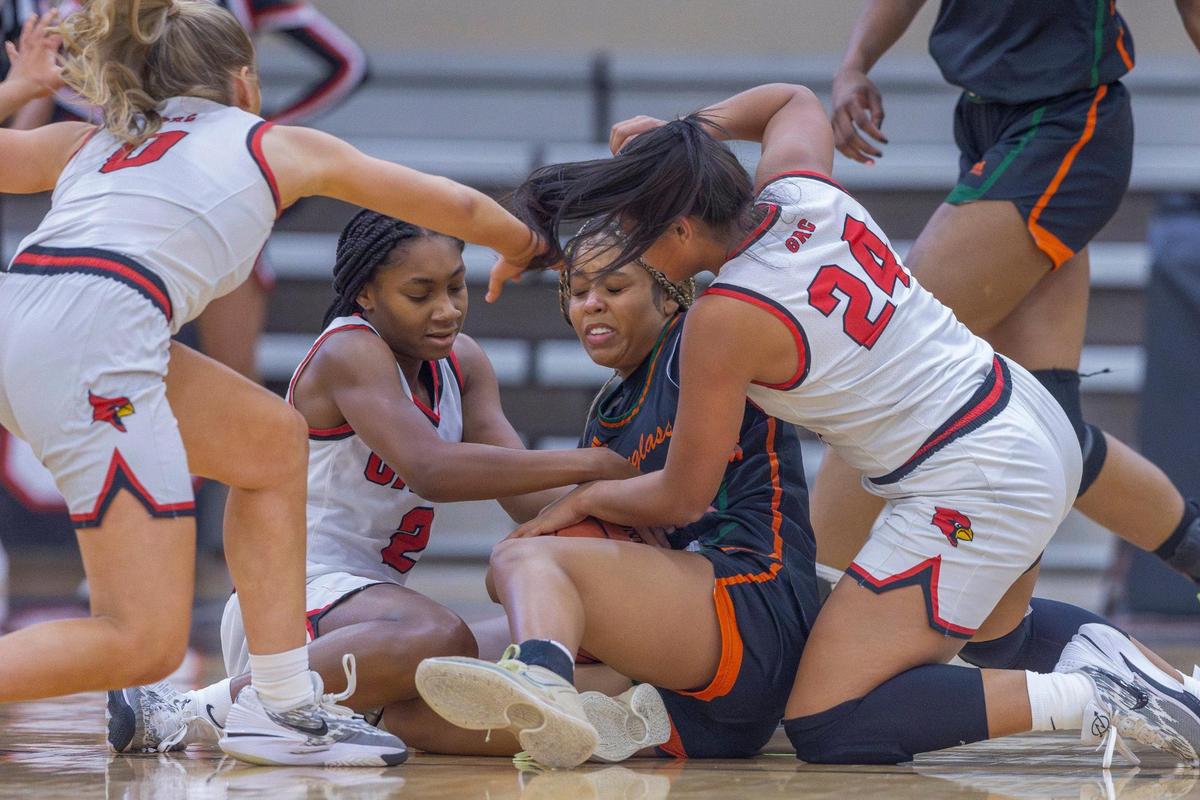 George Rogers Clark’s Kennedy Stamper (0), Teigh Yeast (2) and Makili Tabor (24) fight for a loose ball with Frederick Douglass’ Niah Rhodes during Friday’s game in Winchester.