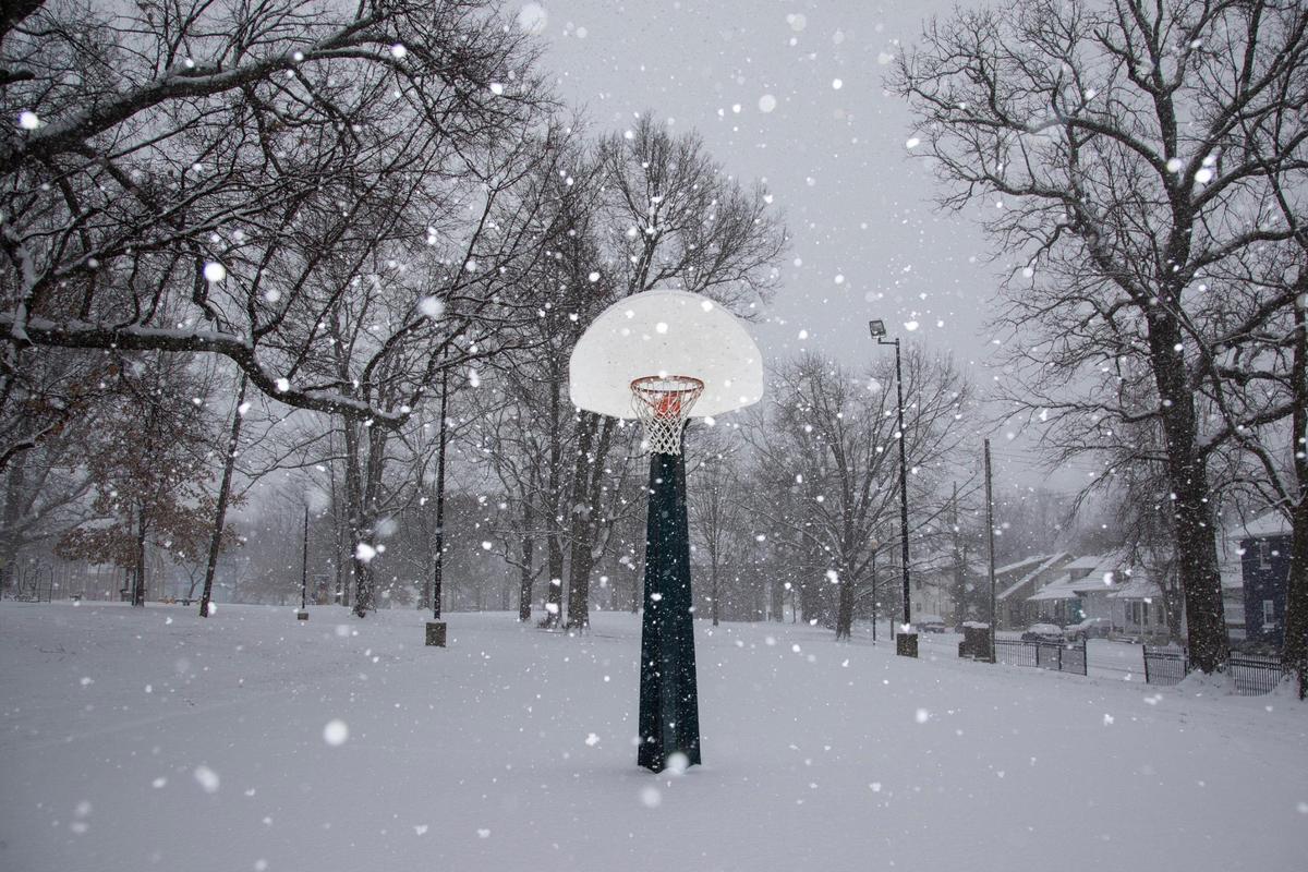Snow falls on basketball hoops in Duncan Park in Lexington, Ky., Thursday, January 6, 2022.