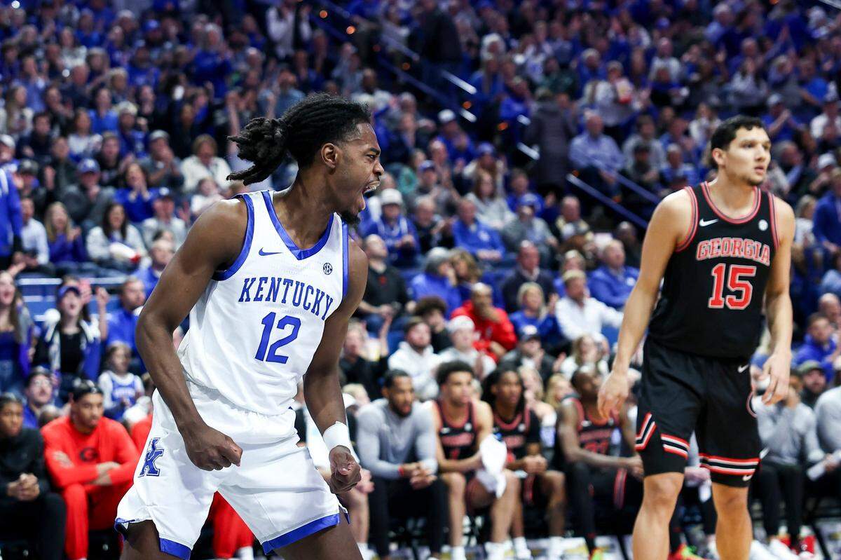 Kentucky guard Antonio Reeves (12) celebrates dunking for a score against Georgia during Saturday’s game at Rupp Arena.