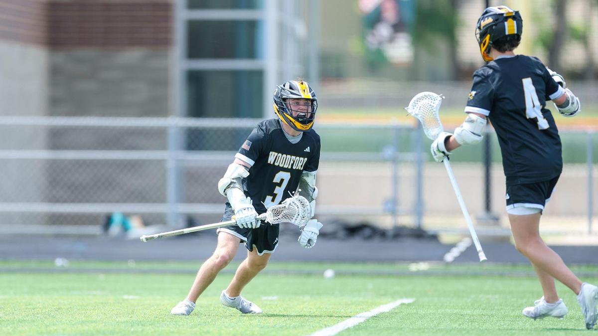 Woodford County’s Aidan McMahon (3), left, and Woodford County’s Behr Wheeler (4) celebrate a second-half goal during the Yellowjacket’s 16-6 win over Frederick Douglass in the 2025 KHSAA Boys’ Lacrosse State Tournament quarterfinals, Saturday.
