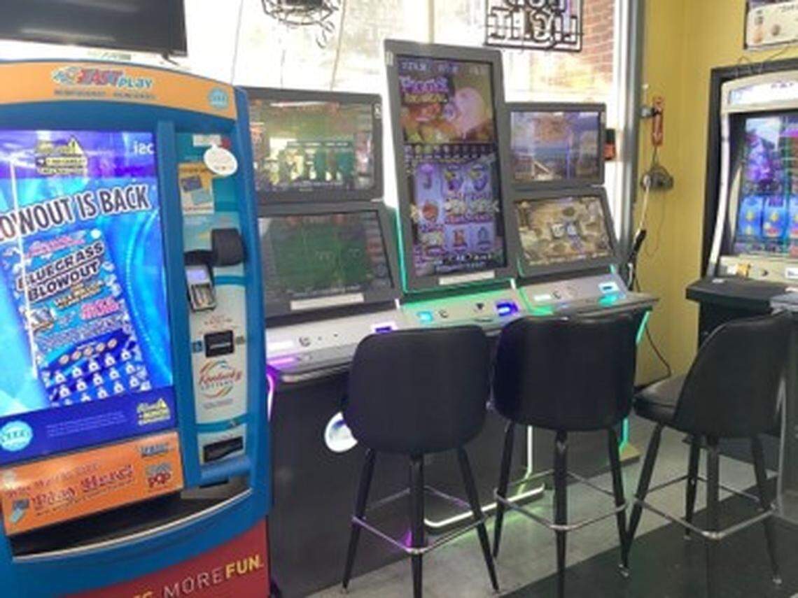 A bank of unregulated gambling machines sit beside a Kentucky Lottery vending machine inside a convenience store in Frankfort. The Kentucky Lottery said it has documented more than 1,100 machines at lottery retailers across the state.
