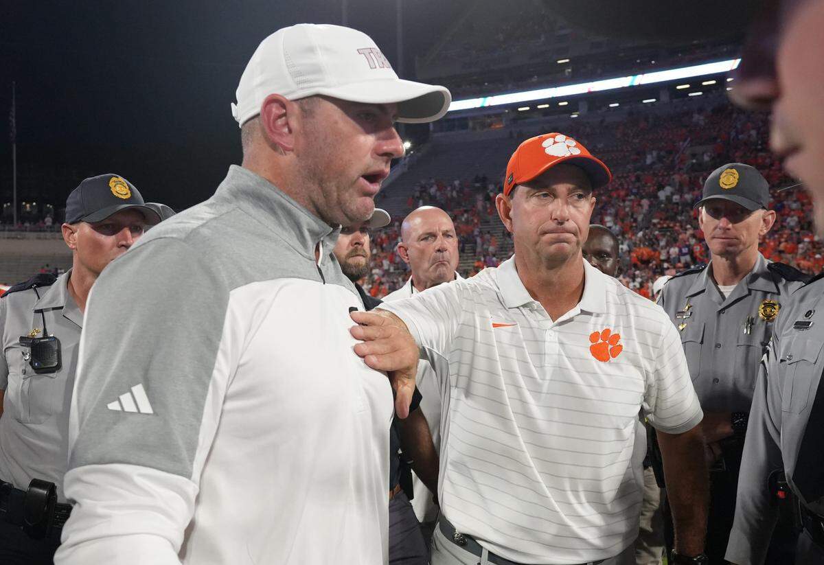 Troy coach Gerad Parker, left, the former Kentucky Wildcats wide receiver and graduate assistant coach, met Clemson head man Dabo Swinney, right, after the Tigers rallied from 16-3 down at halftime to beat the Trojans 27-16 on Sept. 6 at Clemson.