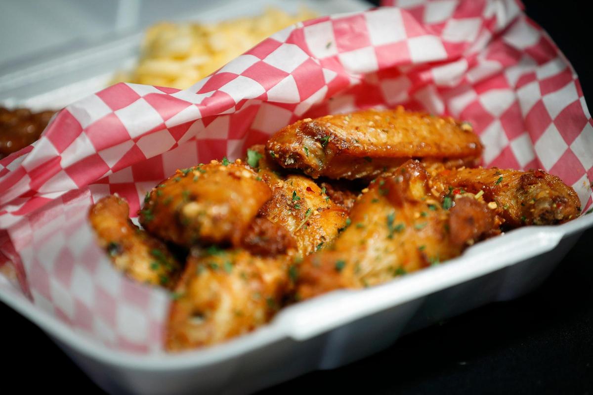 Smoked chicken wings served with baked beans and macaroni and cheese at Mr. Krabs & Bean’s BBQ in Lexington, Ky., Thursday, Nov. 19. 2020.