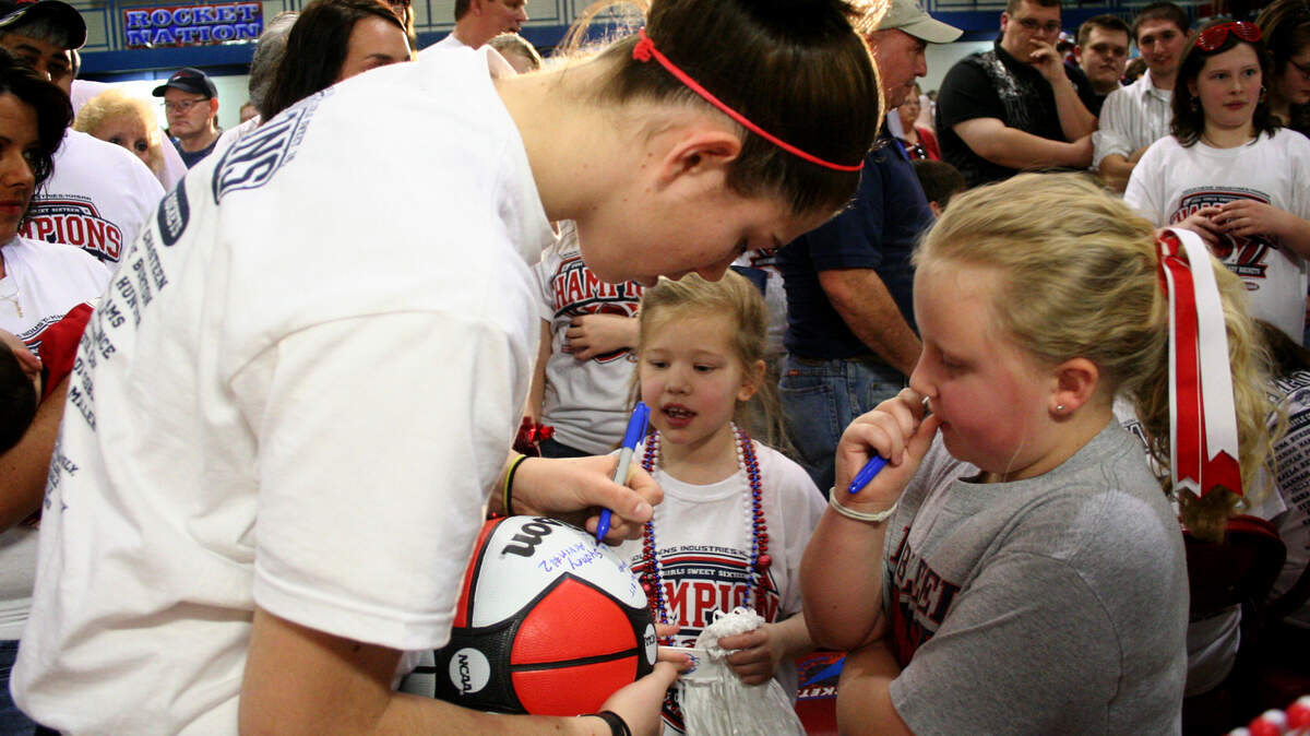 State tournament MVP Sara Hammond signed a basketball for Sierra Hansel, 9, right, as Mya Grace Hunt, 5, watched.