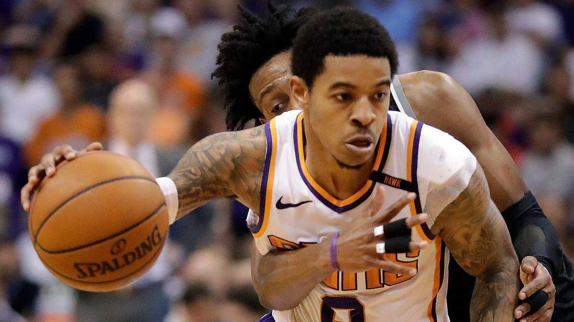 Sacramento Kings guard De’Aaron Fox tries to strip the ball from Phoenix Suns guard Tyler Ulis (8) during the second half of an NBA basketball game Tuesday, April 3, 2018, in Phoenix. (AP Photo/Matt York)