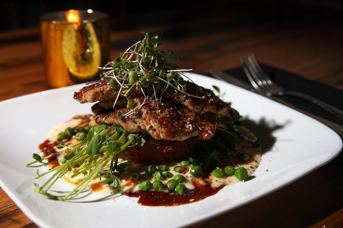 Char sui glazed pork tenderloin with seasoned sweet potato and garlic toum at Graze.