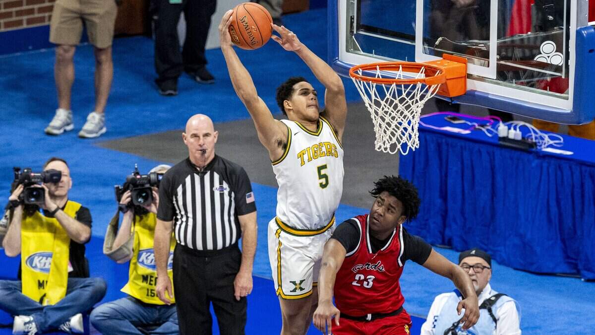 St. X’s Joshua Lindsay (5) grabs an alley-oop and then throws down a dunk over George Rogers Clark’s CJ Thomas (23) during the finals of the 2026 UK HealthCare Boys’ Basketball Sweet 16 state tournament, Saturday, March 21, 2026 at Rupp Arena in Lexington, Ky.