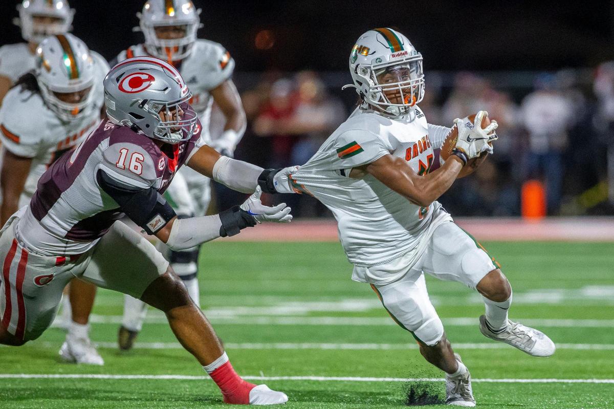 Corbin’s Jacob Smith gets hold of Frederick Douglass’s Darion Talbert on Friday night. Smith finished with six tackles and an interception in the Redhounds’ win.
