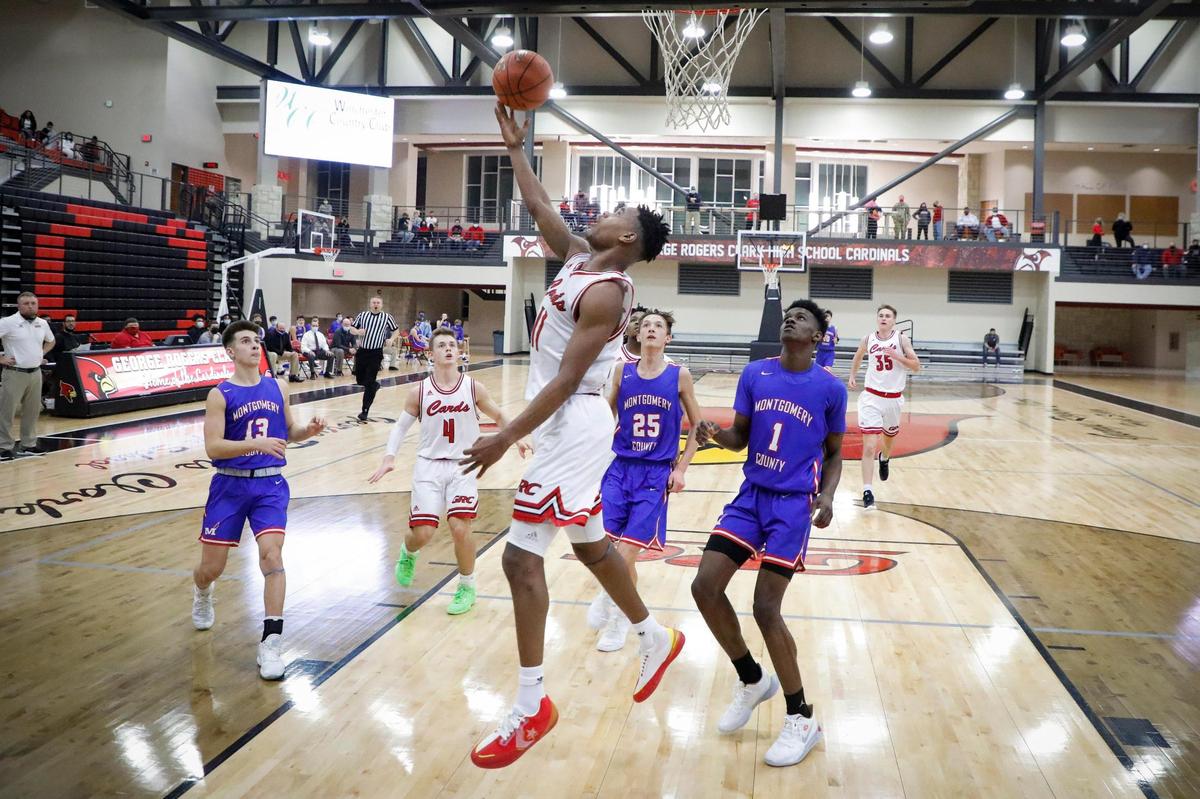 Clark County’s Jerone Morton (11) shoots past Montgomery County’s Trey Carroll (13), Breccan Decker (25) and Rickey Lovette (1).