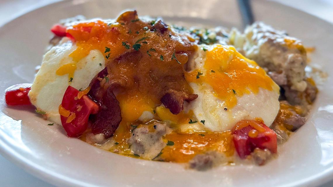 The Danville Hot Brown ($13) at Biscuit Daddies, is an open-faced buttermilk biscuit covered in sausage gravy and topped with two fried eggs, two strips of bacon, diced Campari tomatoes and melted cheddar cheese. The breakfast and lunch restaurant, shown Friday, June 6, 2025, opened at 373 Virginia Ave. unit 130, in Lexington, Ky., after moving from its Danville location.