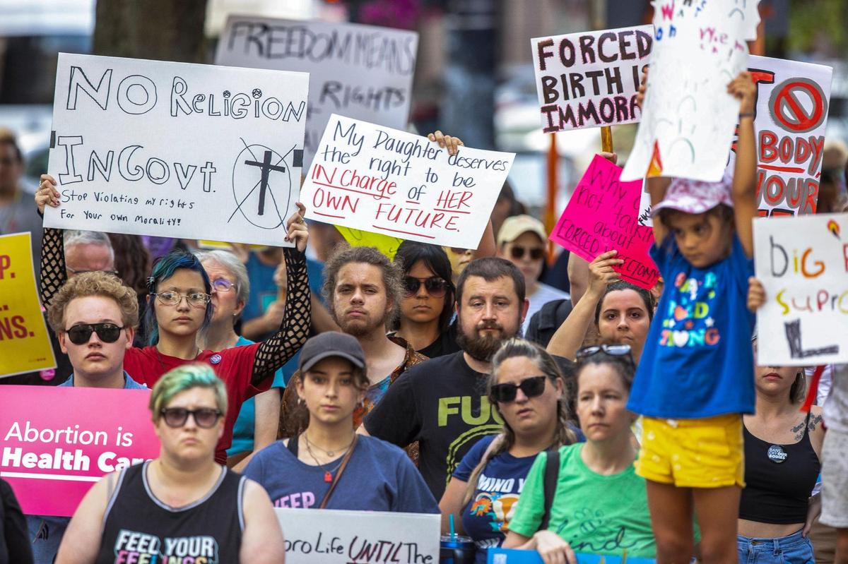 People gather near Robert F. Stephens Courthouse Plaza in downtown Lexington, Ky., on Friday, June 24, 2022 to protest the U.S. Supreme Court’s overturning of Roe v. Wade.