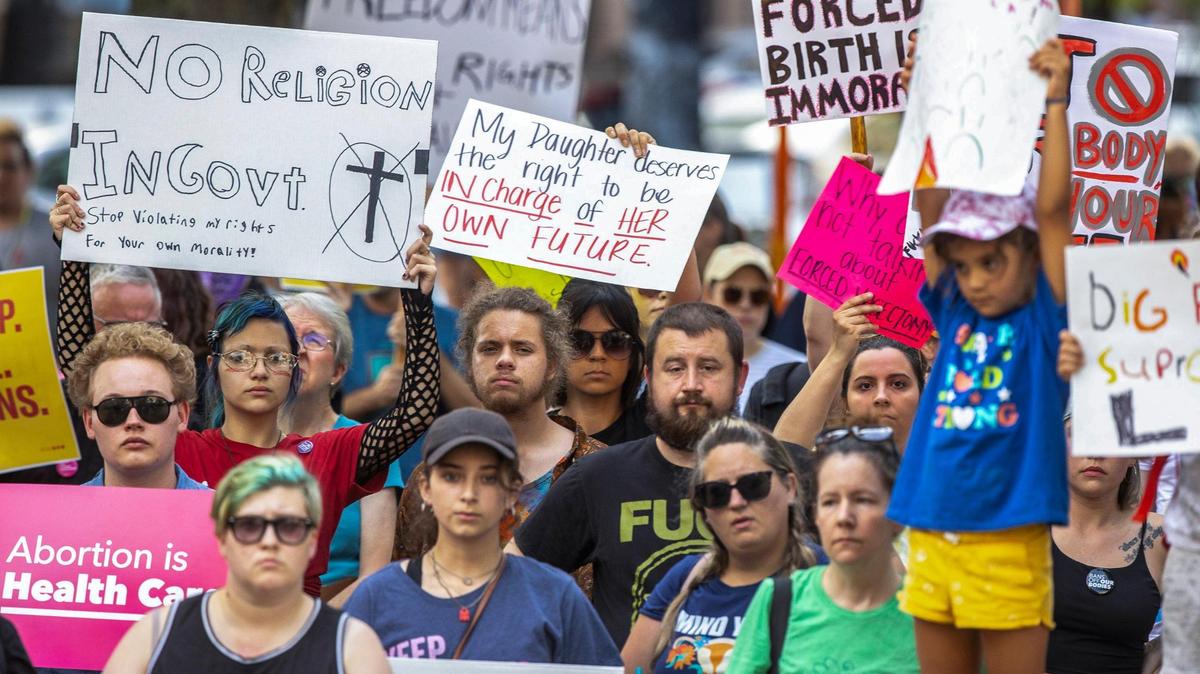 People gather near Robert F. Stephens Courthouse Plaza in downtown Lexington, Ky., on Friday, June 24, 2022 to protest the U.S. Supreme Court’s overturning of Roe v. Wade.