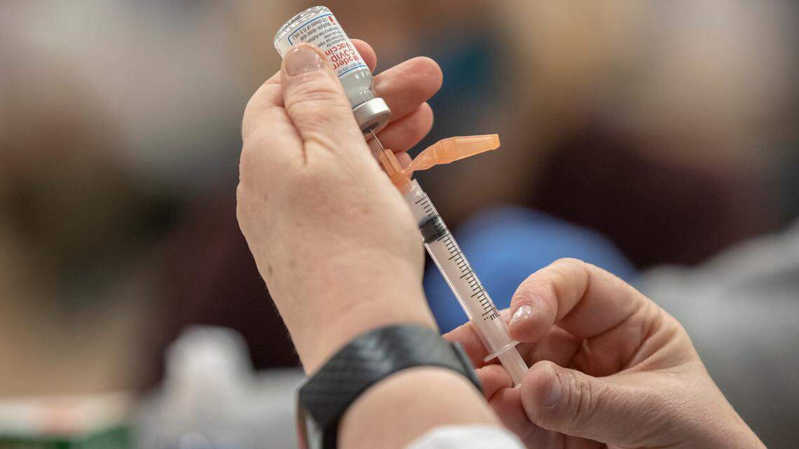 A health care worker prepares a dose of the COVID-19 vaccine at a Lexington-Fayette County Health Department vaccination clinic at Consolidated Baptist Church in Lexington, Ky., on Wednesday, Feb. 3, 2021.