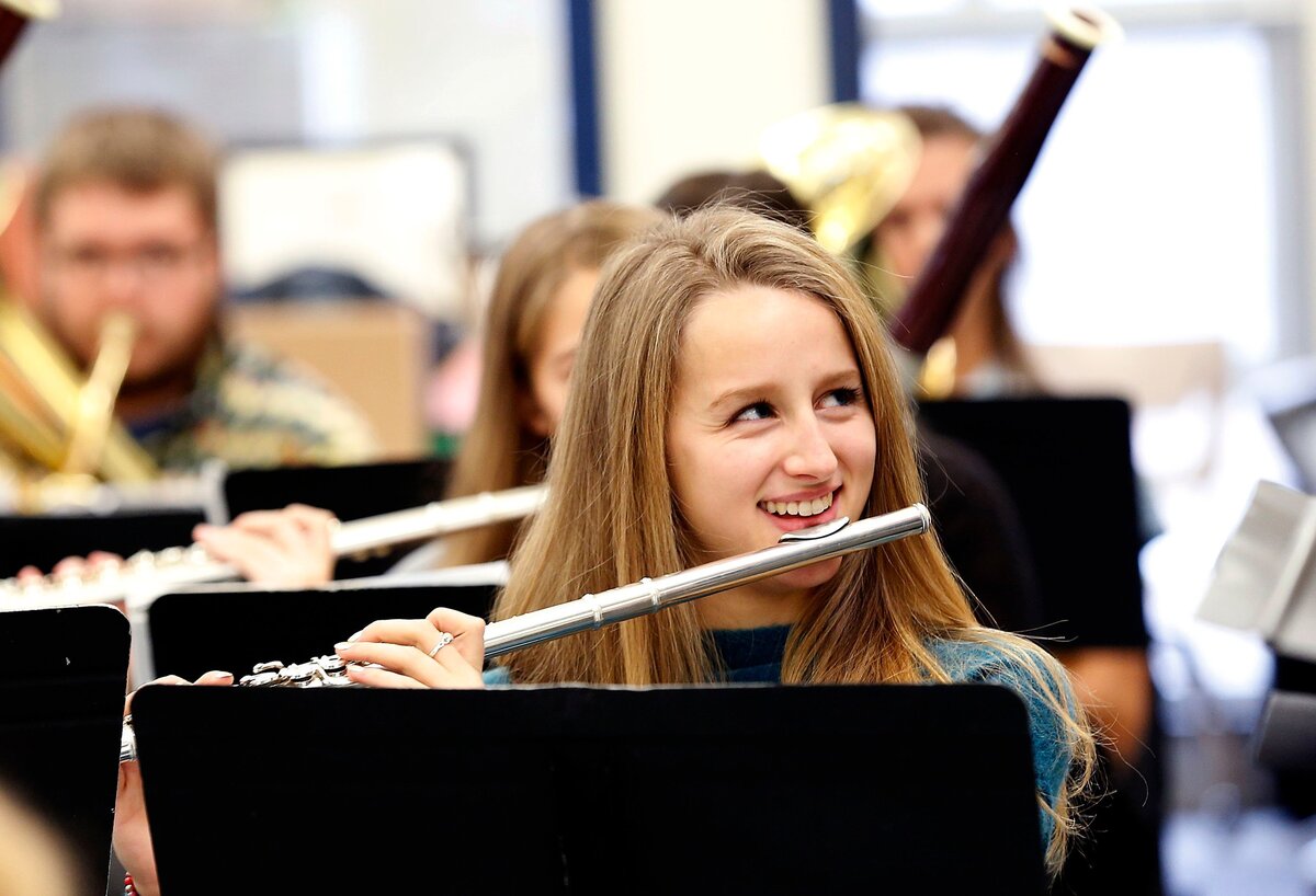 Henry Clay student Katie Demos smiled while playing her flute during class at the high school in Lexington.
