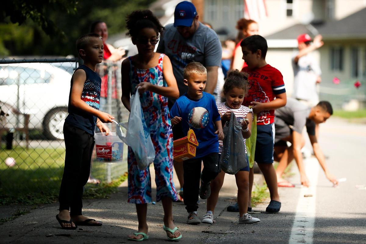 Children run for candy during a Fourth of July parade along Main Street in Lynch, Ky., Saturday, July, 3, 2021.