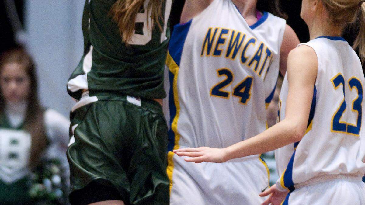 Newport Catholic's Nicole Kiernan blocked a shot by Bishop Brossart's Sarah Futscher. Kiernan had 18 points and 14 rebounds.    