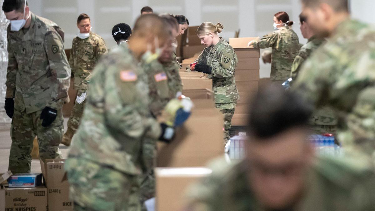 Members of the Kentucky National Guard help prepare boxes of food for God’s Pantry Food Bank in Lexington, Ky., Tuesday, April 7, 2020.