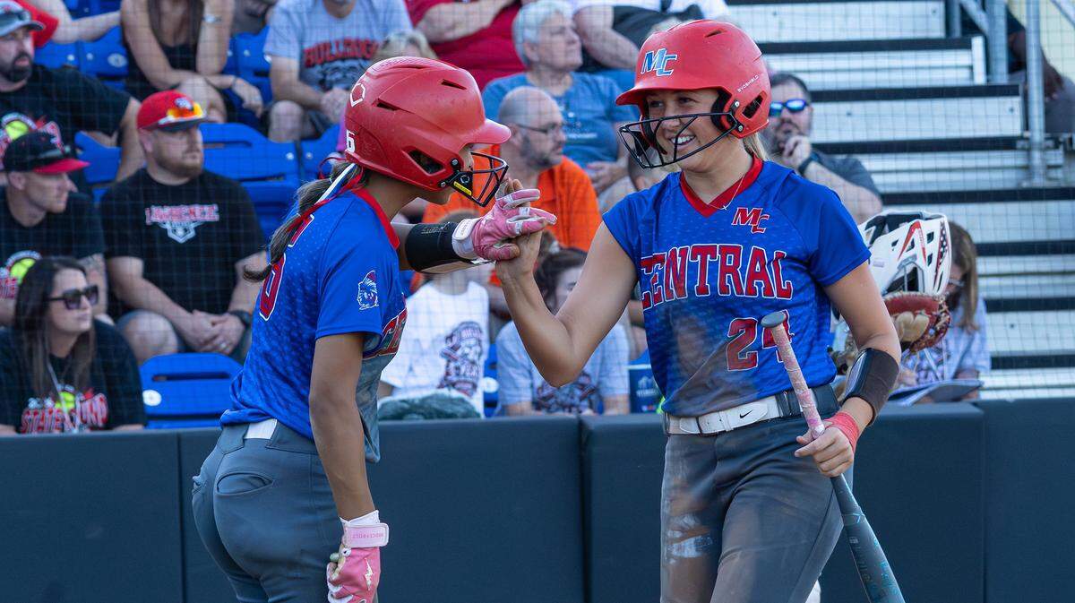 Madison Central's Jenna Scarberry high-fives teammate Reille Parks as she crosses home plate during the UK HealthCare Softball State Tournament first round game between Madison Central and Lawrence County at John Cropp Stadium in Lexington, Ky, on June 4, 2026