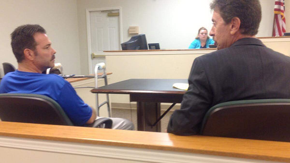 Former state Agriculture Commissioner Richie Farmer talked to his attorney, Richard Guarnieri, during a court hearing Thursday on Farmer's request for lower child-support payments. Photo by Jack Brammer | Staff
