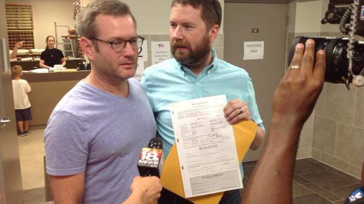 Following the U.S. Supreme Court's ruling, Marcus Roland, left, and Scott Shive received the first marriage license issued to a same-sex couple in Lexington on Friday afternoon at the Fayette County Clerk's office. Photo: Janet Patton