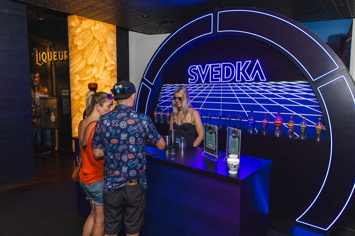Guests sample cocktails made from Svedka Vodka at a booth inside The Sazerac House