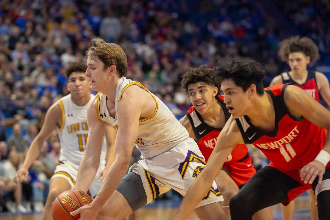 Lyon County’s Travis Perry drives the ball as Newport’s Noah Silverton, right, follows during the Boys’ Sweet 16 tournament at Rupp Arena on Thursday.