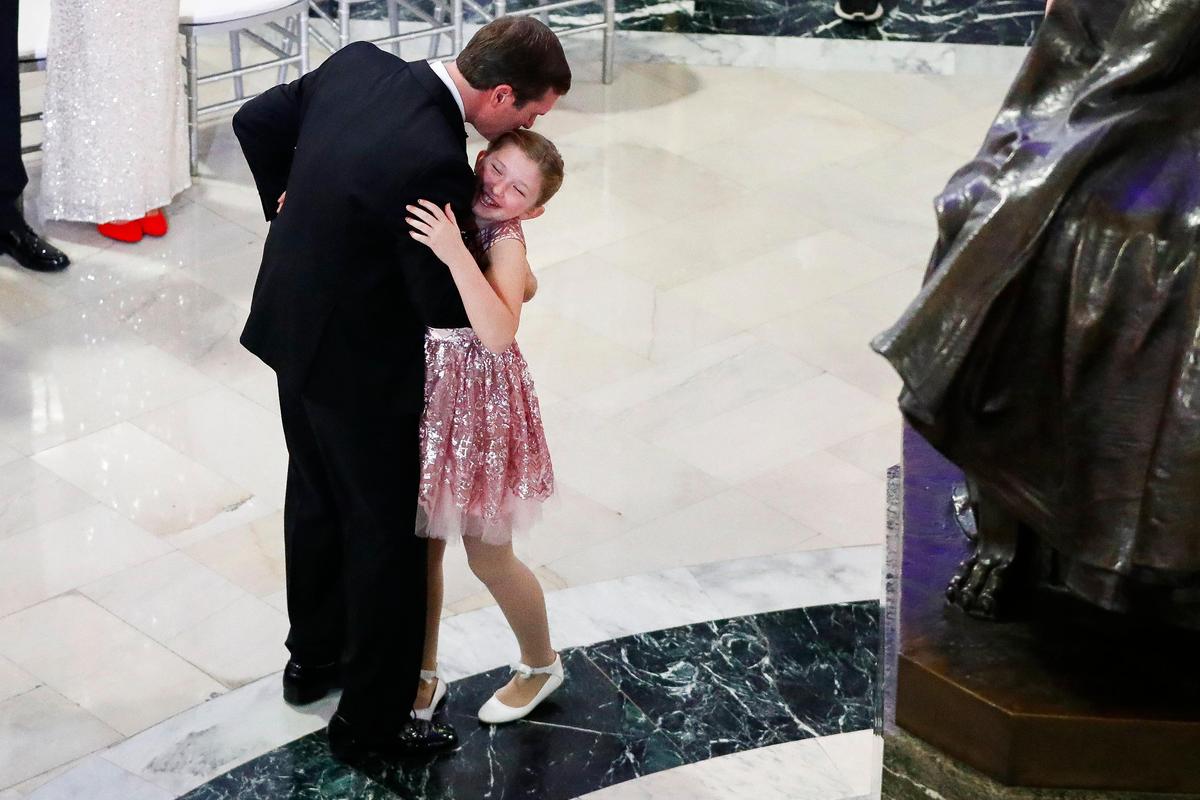 Kentucky Gov. Andy Beshear dances with his daughter Lila in the Capitol rotunda following the Grand March in the state Capitol in Frankfort, Ky., Tuesday, Dec. 10, 2019.