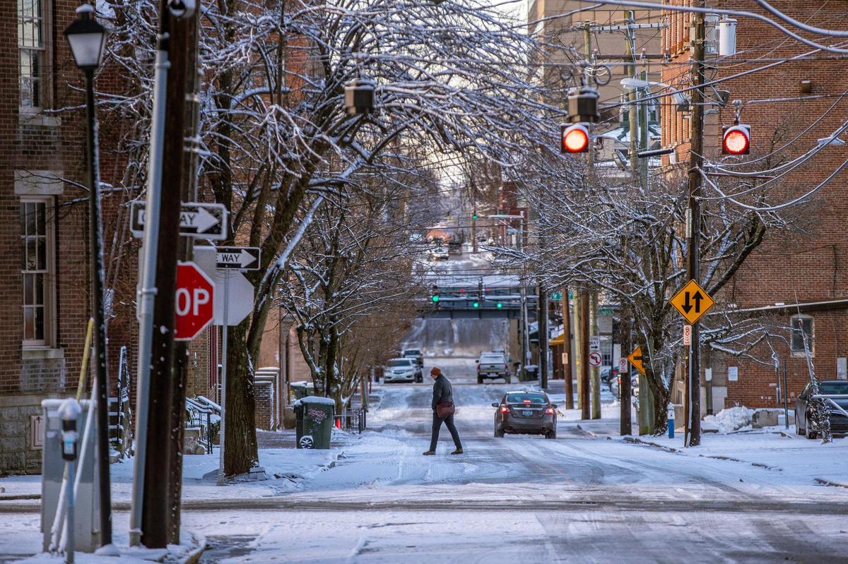 A pedestrian crosses North Mill Street in downtown Lexington, Ky., on Thursday, Jan. 22, 2022.