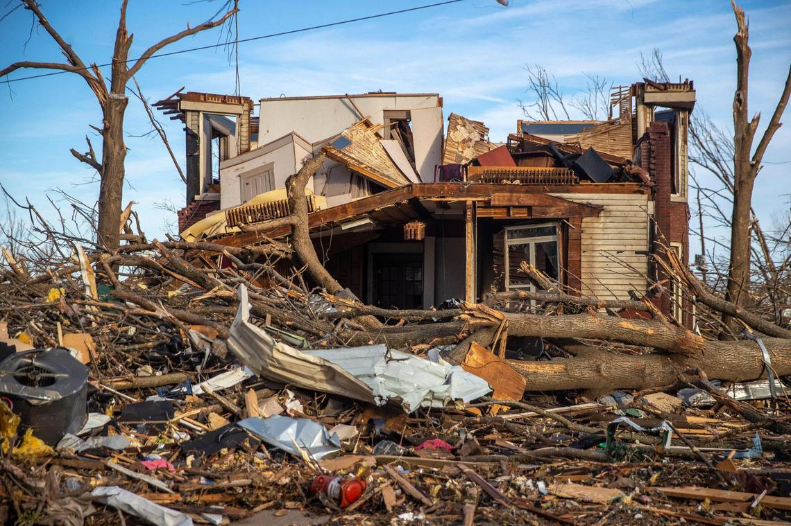 Debris litters downtown Mayfield, Ky., in front of a damaged building Sunday, Dec. 12, 2021. In Western Kentucky, more than 77,000 are without power.