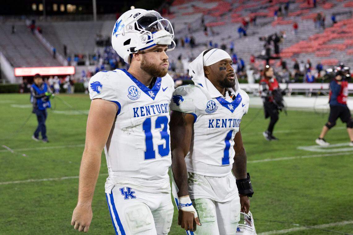 Kentucky quarterback Devin Leary (13) and running back Ray Davis (1) walk off the field after their team’s 51-13 loss at Georgia. The Wildcats were held to 183 yards of offense,