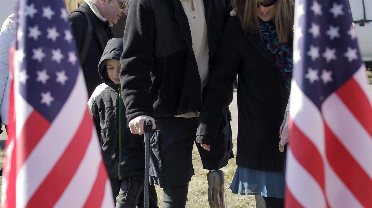 Cpl. Matt Bradford and his wife, Amanda, walked to a tent on their lot Thursday during the groundbreaking ceremony for their new house in Jessamine County.