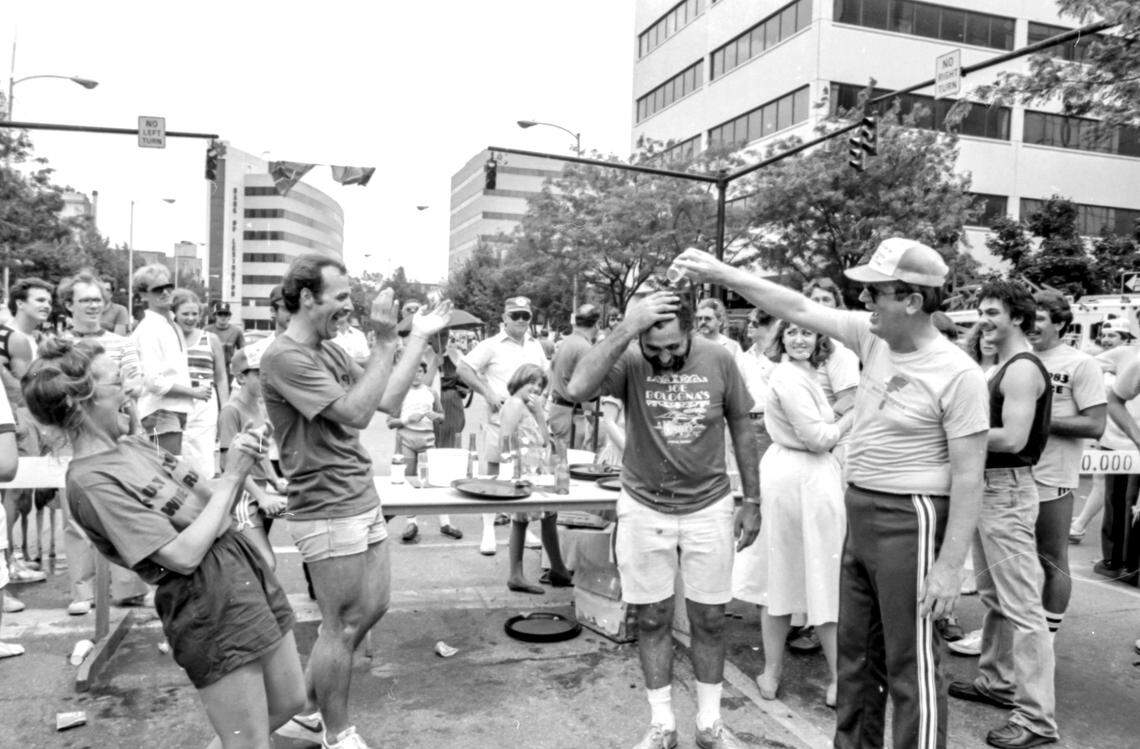 On July 4, 1983, Martha La Follette and Chuck Dean, who won the waiters’ race that day, laughed as their boss Joe Bologna, was doused with wine by Will Murphy.