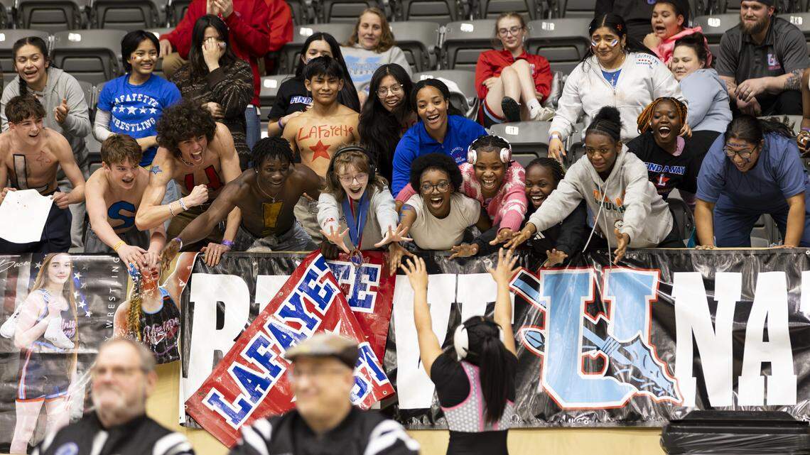 Lafayette’s Amy Velasco, at bottom right, saluted the Lafayette cheering section for their support during her 145-pound finals win in the 2026 KHSAA Girls State Wrestling Championships at the Kentucky Horse Park’s Alltech Arena on Saturday.