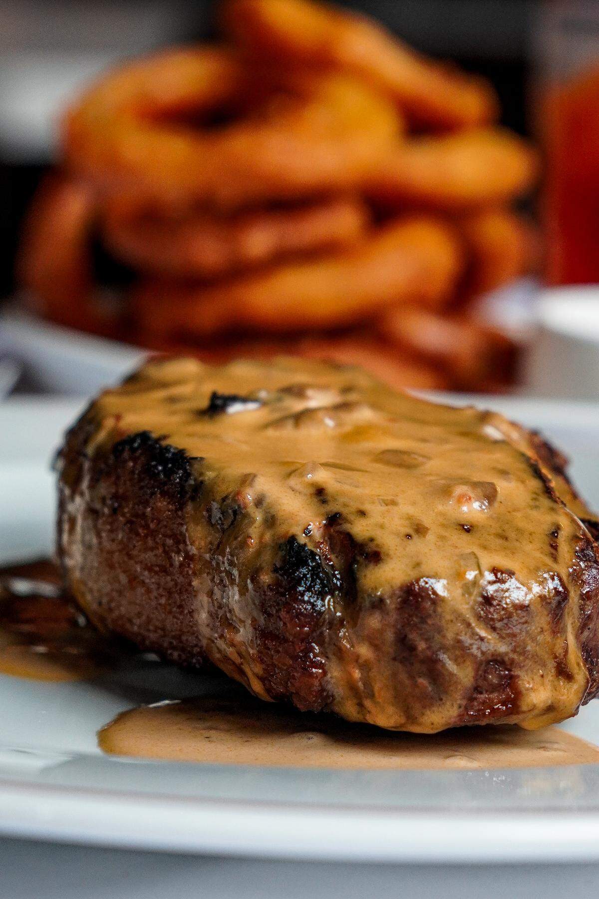 A 16 oz. New York strip steak ($70) topped with Diane sauce ($5) at Silk’s Steakhouse located inside The Aldenberg Hotel in Versailles, Ky.