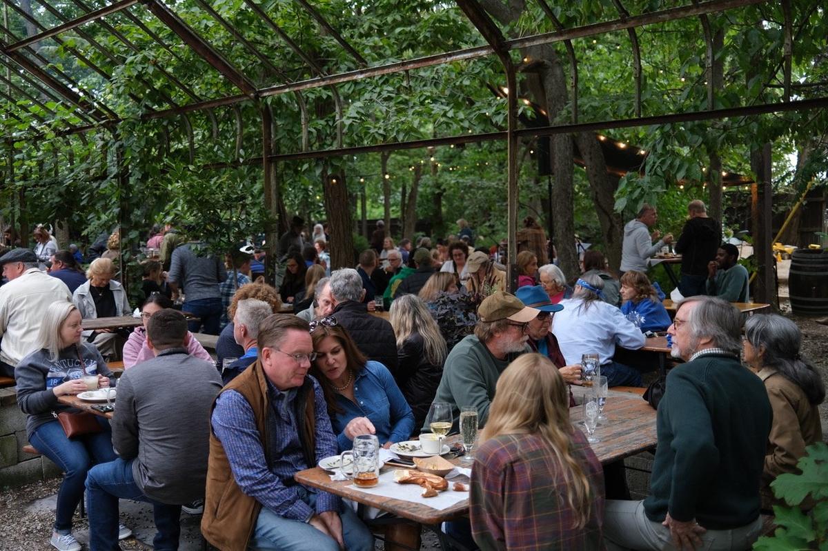 People packed the greenhouse that was hit by the fallen tree for the 2022 Oktoberfest at Kentucky Native Cafe behind Michler’s florists in Lexington, Ky.
