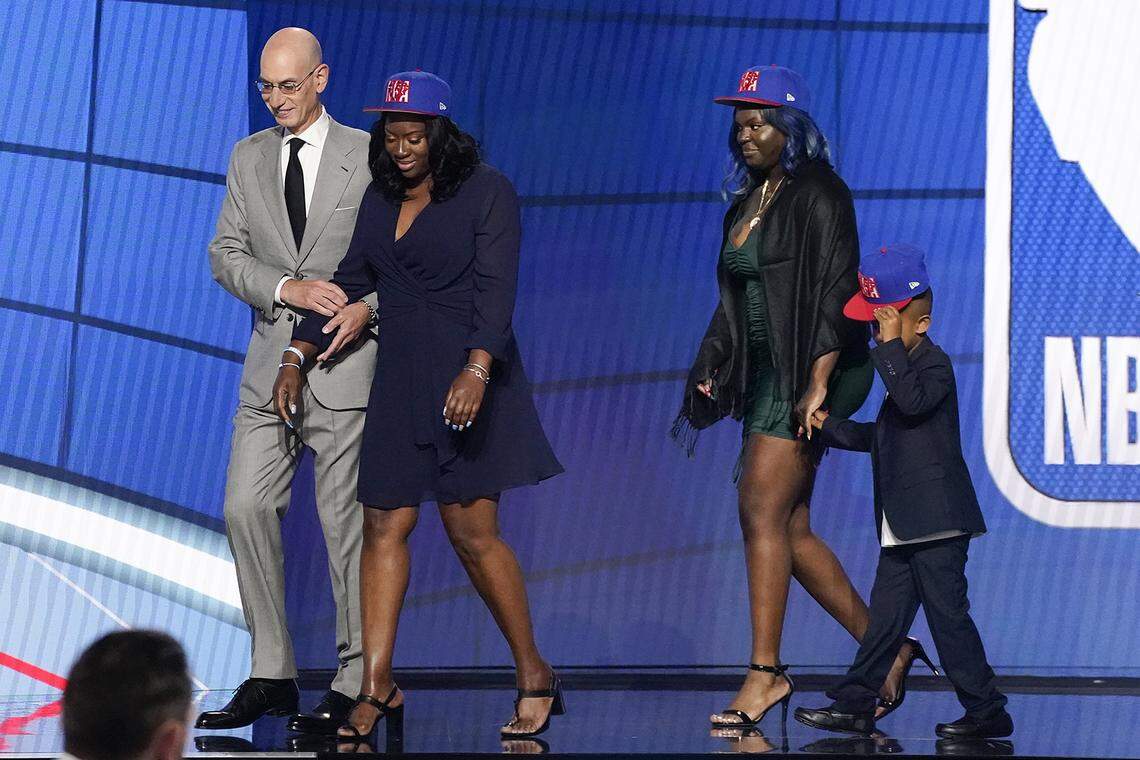 NBA Commissioner Adam Silver escorts relatives of former Kentucky guard Terrence Clarke after a tribute to Clarke during the NBA basketball draft, Thursday, July 29, 2021, in New York. Clarke was killed in a car accident in April 2021.
